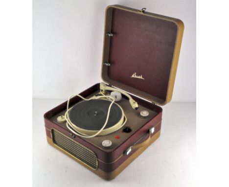 A late 1950s Bush four speed table record player, Garrard 4SP with built-in speaker, in a red and cream textured case