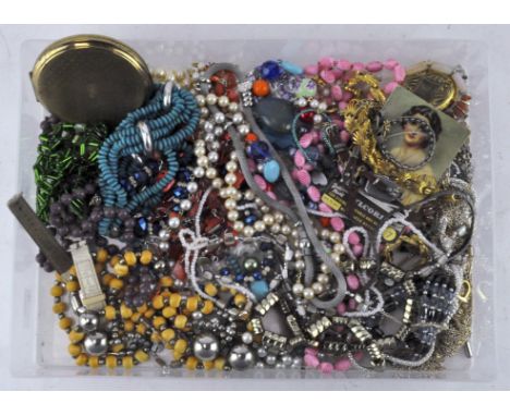 A box of costume jewellery, including a Stratton compact, pendants, necklaces earrings and more