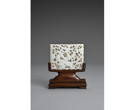 A CHINESE WHITE JADE PLAQUE ON STAND, 19/20TH CENTURY. Carved and pierced featuring a dragon on scrolling foliage. On a carve