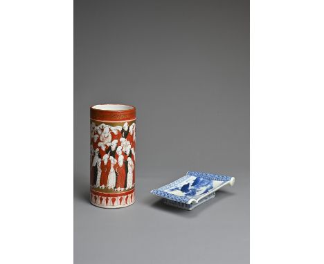 A JAPANESE PORCELAIN BLUE AND WHITE SCROLL-SHAPED SMALL DISH AND A KUTANI MILLION MONK PATTERN CYLINDRICAL VASE, MEIJI PERIOD