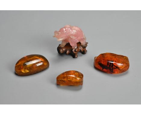 THREE MIXED AMBER AND RESIN BOULDERS WITH PINK QUARTZ MODEL OF AN ELEPHANT. The part pressed amber mixed resin boulders with 