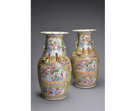 A PAIR OF CHINESE YELLOW GROUND FAMILLE ROSE PORCELAIN VASES, 19/20TH CENTURY. Of baluster form decorated with figures in car