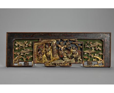 A CHINESE LACQUERED AND GILT WOOD PANEL, 19TH CENTURY. Rectangular panel carved in relief with scene of figures in a courtyar