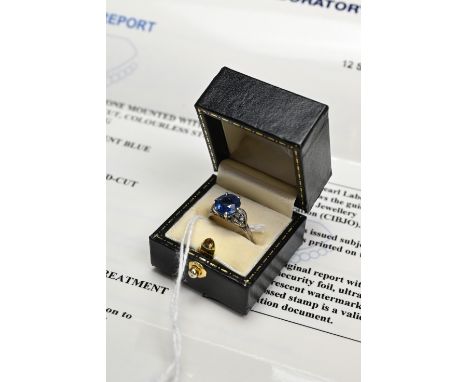 A CHOW TAI FOOK SAPPHIRE AND DIAMOND DRESS RING, WITH LAB REPORT. A round faceted mixed cut sapphire set in 18K white gold mo