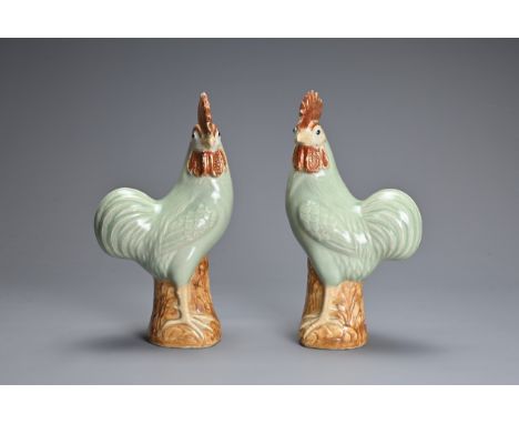 A MIRRORED PAIR OF CHINESE PORCELAIN MODELS OF ROOSTERS, EARLY 20TH CENTURY. Each pale celadon glazed with impressed makers m