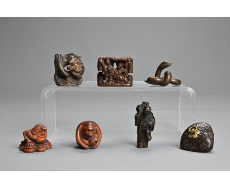A COLLECTION OF EIGHT CHINESE AND JAPANESE CARVED WOOD NETSUKE, 19TH CENTURY AND LATER. Comprising: a toad, a serpent, signed
