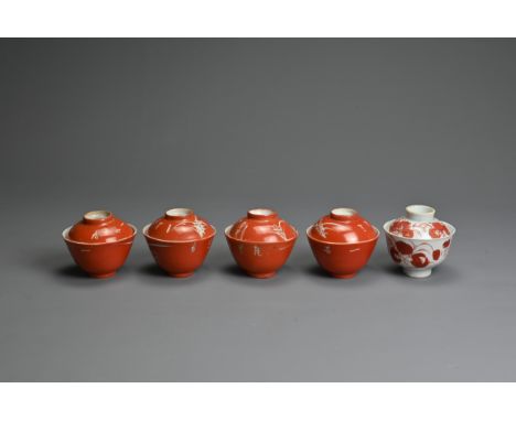 A GROUP OF CHINESE PORCELAIN CUPS AND COVERS, LATE QING DYNASTY. To include a set of four coral ground cups and covers with T