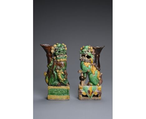 TWO CHINESE SANCAI GLAZED POTTERY JOSS STICK HOLDERS, QING DYNASTY. Buddhistic lions modelled seated on rectangular plinths w