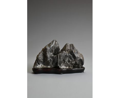 A SCHOLARS ROCK OR SUISEKI STONE BOULDER. In the from of a mountain range on a fitted wooden stand with inscription to base. 