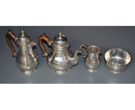 A George V silver four-piece teaset, comprising teapot, hotwater pot, sugar and cream, each of baluster form with domed finia