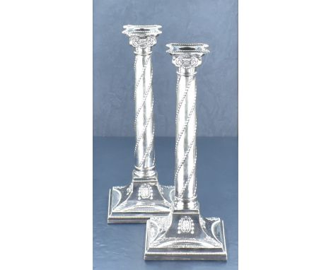 A fine pair of Victorian silver plated column candlesticks, the removable re-entrant square sconce with bead moulding over th