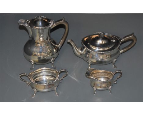 An Edwardian silver four-piece teaset, of oblong baluster form with moulded edge detail and scrolled handles, raised on trefo