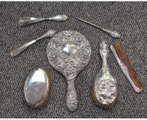 A group of mixed silver mounted dressing table wares, to include hand mirror, hair brush, clothes brush, button hook and shoe