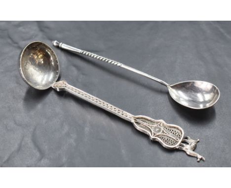 An early 20th century Russian white metal spoon, having an oval bowl with engraved reverse, the slender stem with twisted dec