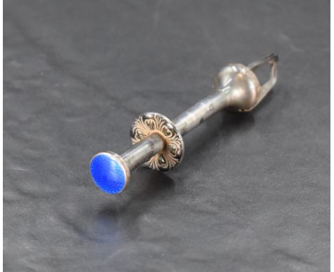 A pair of early 20th century white metal and enamel sugar nips, having moulded decoration, operated by pressing the enamelled
