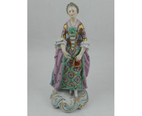 A 20th century German figure of an elegant woman, H. 25cm, together with a ceramic and gilt metal lamp base modelled in the f