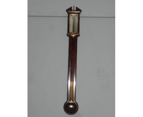 A Worthington of London mahogany stick barometer, the broken pediment with brass finial, the silvered rectangular register wi