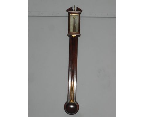 A Worthington of London mahogany stick barometer, the broken pediment with brass finial, the silvered rectangular register wi