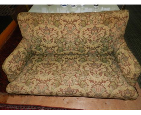 An Edwardian mahogany framed two seater sofa, tapestry upholstered with birds amongst flowers, raised on square tapered legs 