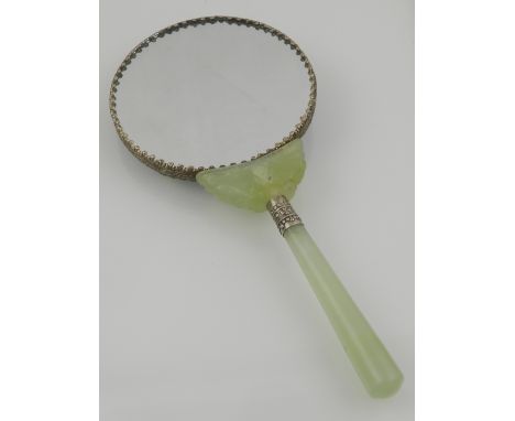 A late 19th / early 20th century Chinese jade handled and enamelled white metal mirror, decorated with dragon chasing pearl. 