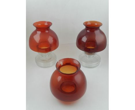 A pair of Finnish Riihimaen glass candle lamps, having red glass shades and clear base, together with one red glass lamp shad
