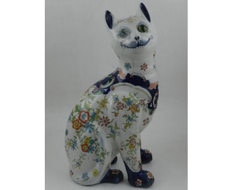 A Galle style ceramic model of a cat, having floral design on a white ground. H: 35cm