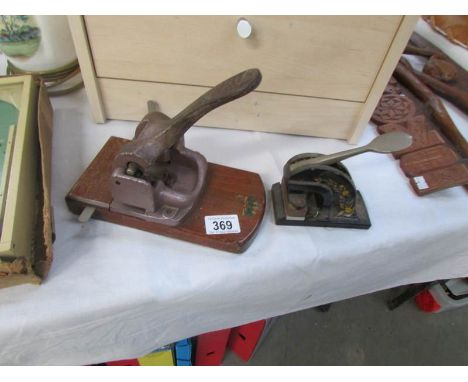 A vintage hole punch and a vintage desk stamp