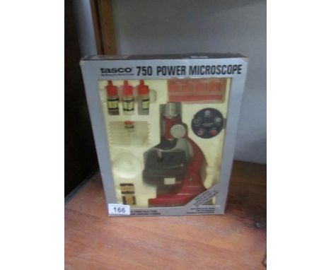 A vintage boxed Tasco 750 microscope