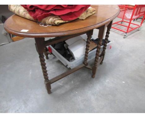 An oak barley twist gate leg table