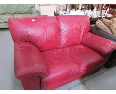 A red leather 2 seat sofa