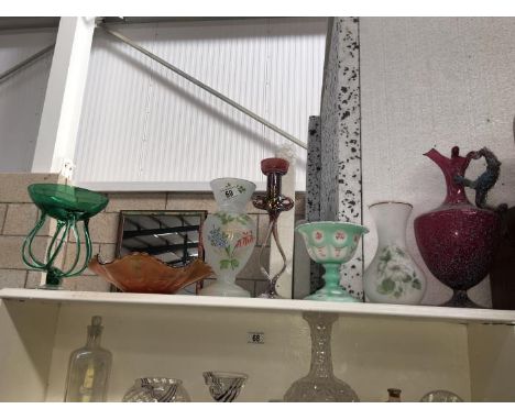 A shelf of interesting glass ware etc