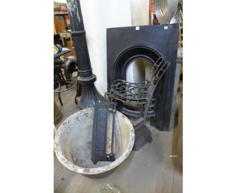A cast iron fire surround, cast iron pot, a pair of cast iron bench ends etc.