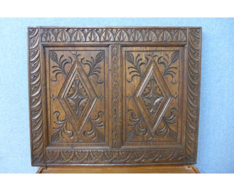 A carved oak panel