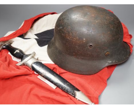 A Third Reich SS dagger, German steel helmet and a Nazi flag