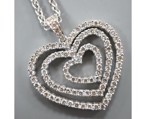 A modern 18k white metal and diamond set graduated concentric heart pendant, 27mm, on an 18ct white gold chain, 44cm, gross w