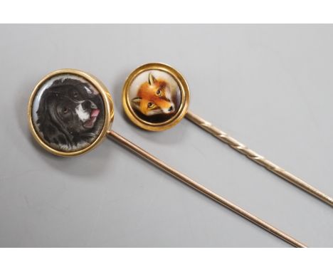 Two early 20th century yellow metal and enamel stick pins, both decorated with the head of a dog, largest, 70mm, gross weight