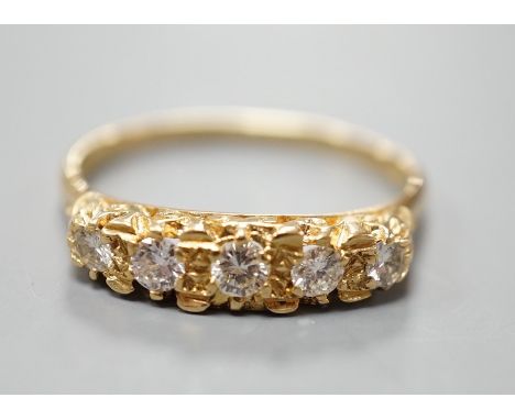 A modern 18ct gold and graduated five stone diamond set half hoop ring, size T, gross weight 3.8 grams.