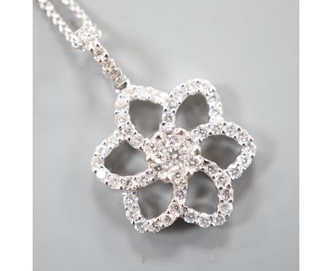A modern 750 white metal and diamond chip set openwork flower head cluster pendant, overall 24mm, on an 18ct white gold fine 
