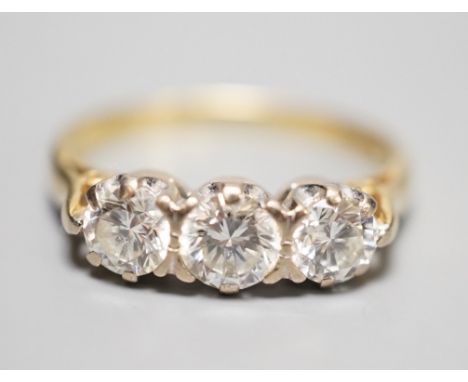 A modern 18ct gold and three stone diamond ring, size L, gross weight 3.3 grams, total diamond weight approx. 0.65ct.