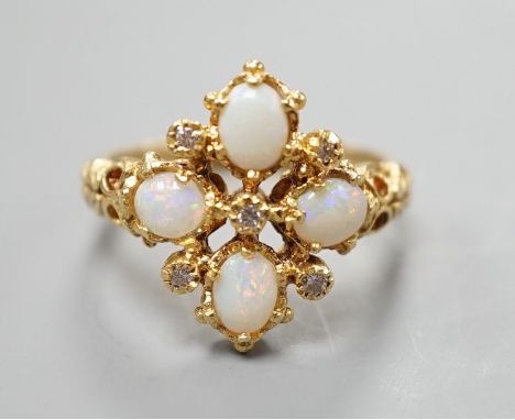 A 1970's 18ct gold, white opal and diamond chip set quatrefoil shaped ring, size O, gross weight 6.1 grams.