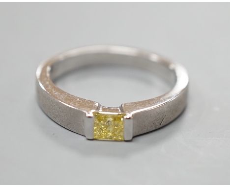 A modern sandblasted platinum and solitaire rectangular cut fancy yellow diamond set ring, size M/N, gross weight 7.2 grams, 