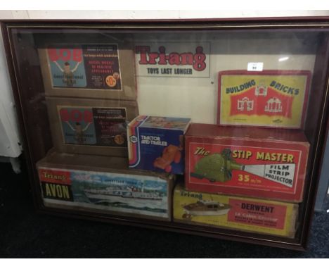 7 boxed Vintage toys housed in a display cabinet including Triang Boats and a projector  [NO RESERVE]