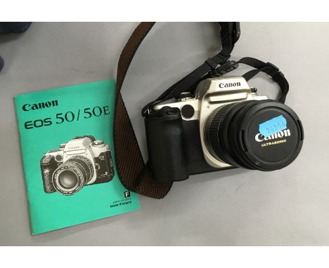 A canon camera with lens [NO RESERVE]