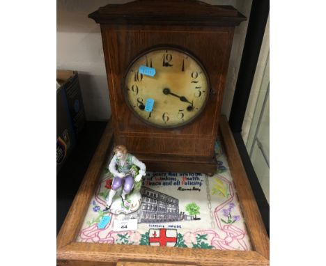 An early 20th century wooden cased Mantle clock and a tray with a sampler under glass in base. [NO RESERVE]