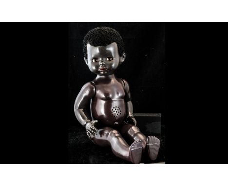 Vintage Black Baby Doll, moving limbs and open and shut eyes, with black curly Afro hair.  She measures 21" high.  