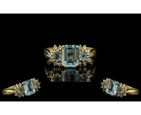 18 Ct Gold Attractive Aquamarine Diamond Set Dress Ring fully hallmarked to interior of shank. The aquamarine of excellent co