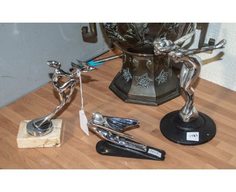 Three Vintage Car Mascots, comprising a  a nude lady, diving with arms outstretched, mounted on a metal base, 8" high, a wing