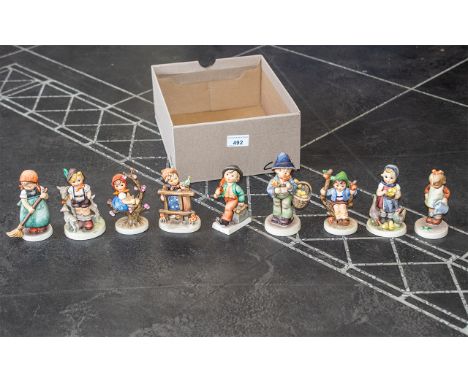 Collection of Goebel Hummel Figures, nine in total, including girl with watering can No. 74, goat herd No. 200, Little Sweepe