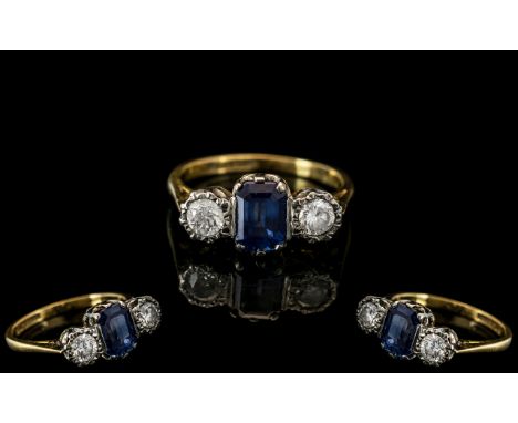 18ct Gold &amp; Platinum 3 Stone Diamond and Sapphire Set Dress Ring. Marked 18ct and Platinum. The Central Step-cut Natural 