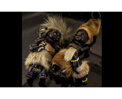 Vintage Family of Native Africans in traditional dress, wearing fur outfits, with beaded jewellery, comprising two adults and